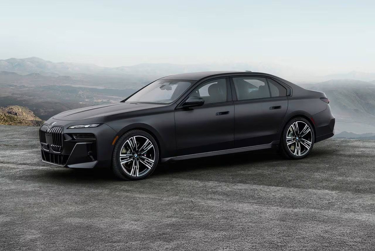 BMW 7 Series on a misty coastal road
