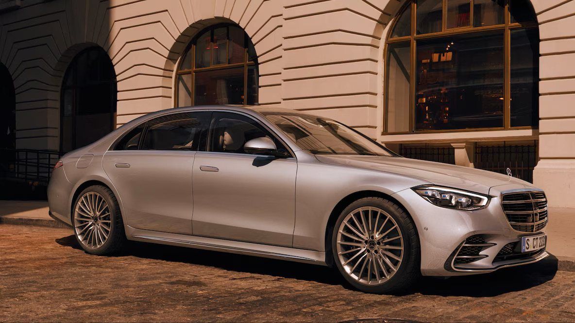 Mercedes-Benz S-Class sedan outside a classic stone building